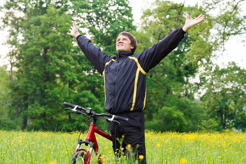 Happy recovering alcoholic enjoying a bike ride in the woods